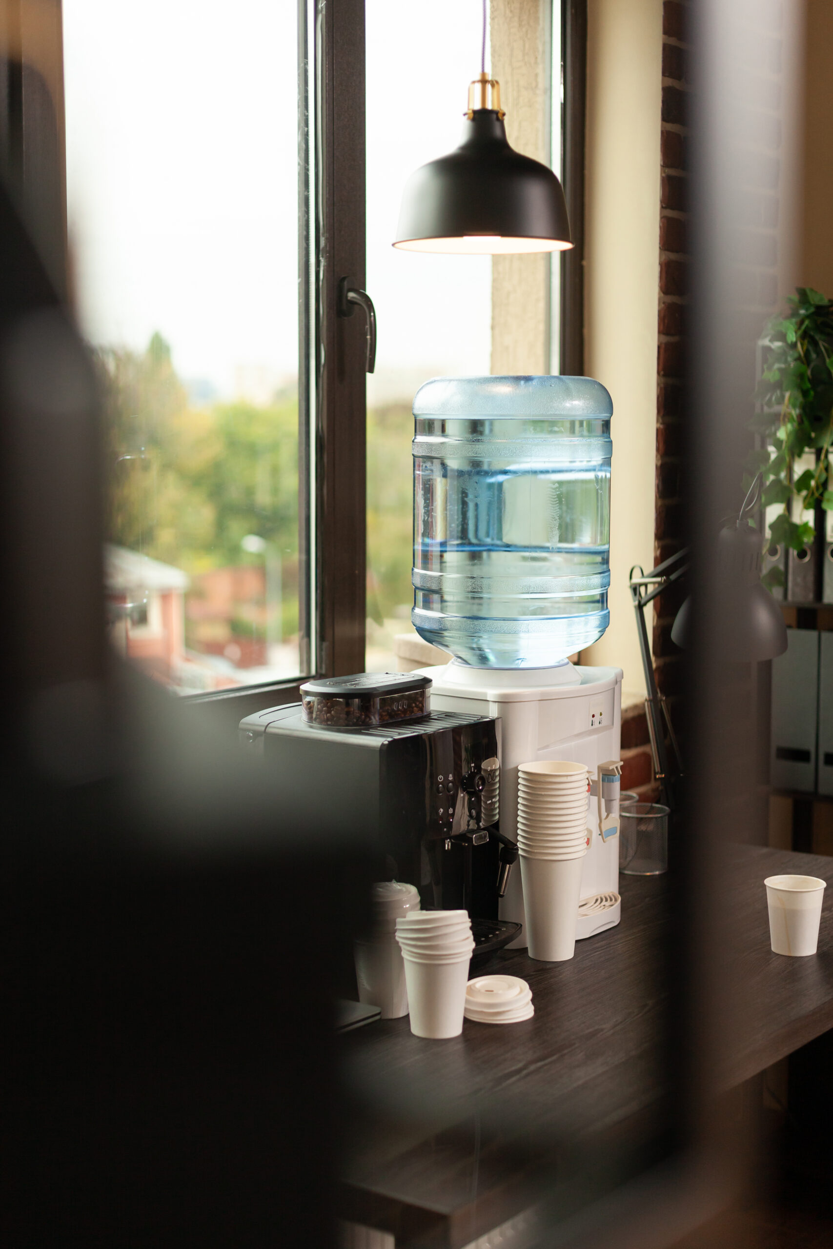 Close up of water dispenser on table in workplace at office. 