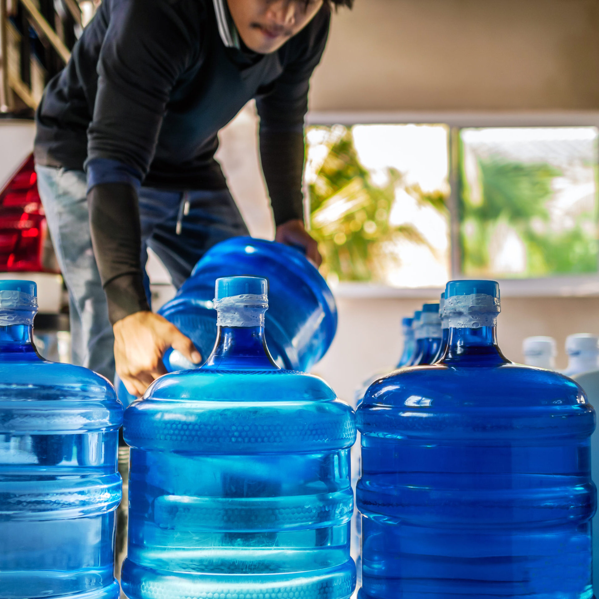 Drinking water clear and clean in blue gallon arranged in a row
